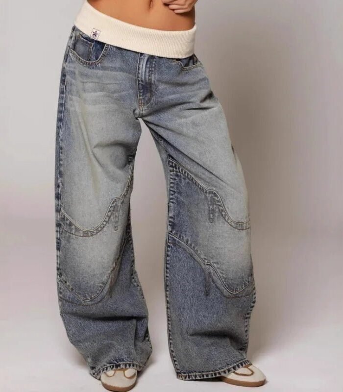 Jeans baggy blu con vita a coste color crema e cuciture curve sulle gambe, indossati con sneakers