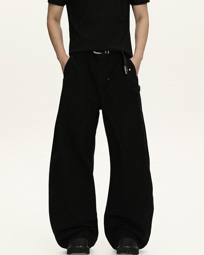 Pantaloni utility neri a gamba larga in cotone indossati con t-shirt nera e cintura in pelle